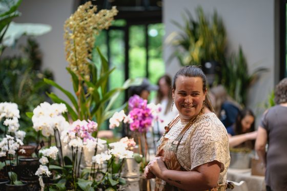 A person working in the Garden Shop looking to the right smiling. 